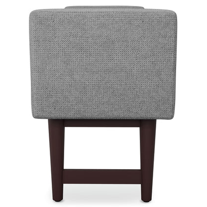 The Scott Upholstered Ottoman Bench features a gray textured fabric backrest and dark wooden legs, displayed from the back against a white background.
