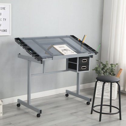 An Adjustable Art Drawing Desk Craft Station Drafting with a glass top, angled surface, 2 non-woven fabric slide drawers, and 4 wheels—shown with art supplies and a black stool in a bright room with light wood floors and tall windows.