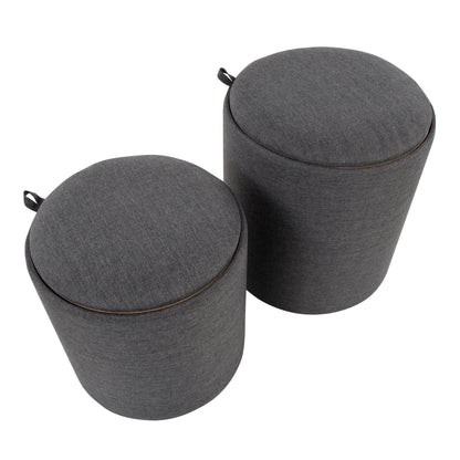 The Tray - Contemporary Nesting Ottoman Set includes two round, dark gray upholstered ottomans with fabric handles on top, shown side by side against a white background.