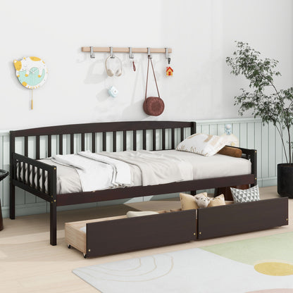 A bright, cozy kids’ room features a Pine Wood Daybed With Two Storage Drawers, Sofa Bed With Bed Platform Of 10 Support Slats, displaying stuffed toys, wall hooks, decorations, a plant, and a colorful rug on light wood flooring.