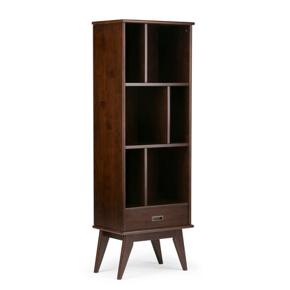 The Draper - Mid Century Wide Bookcase and Storage Unit features a dark brown wooden finish, four open shelves, a bottom drawer, and stands on angled legs for a classic mid-century modern look.