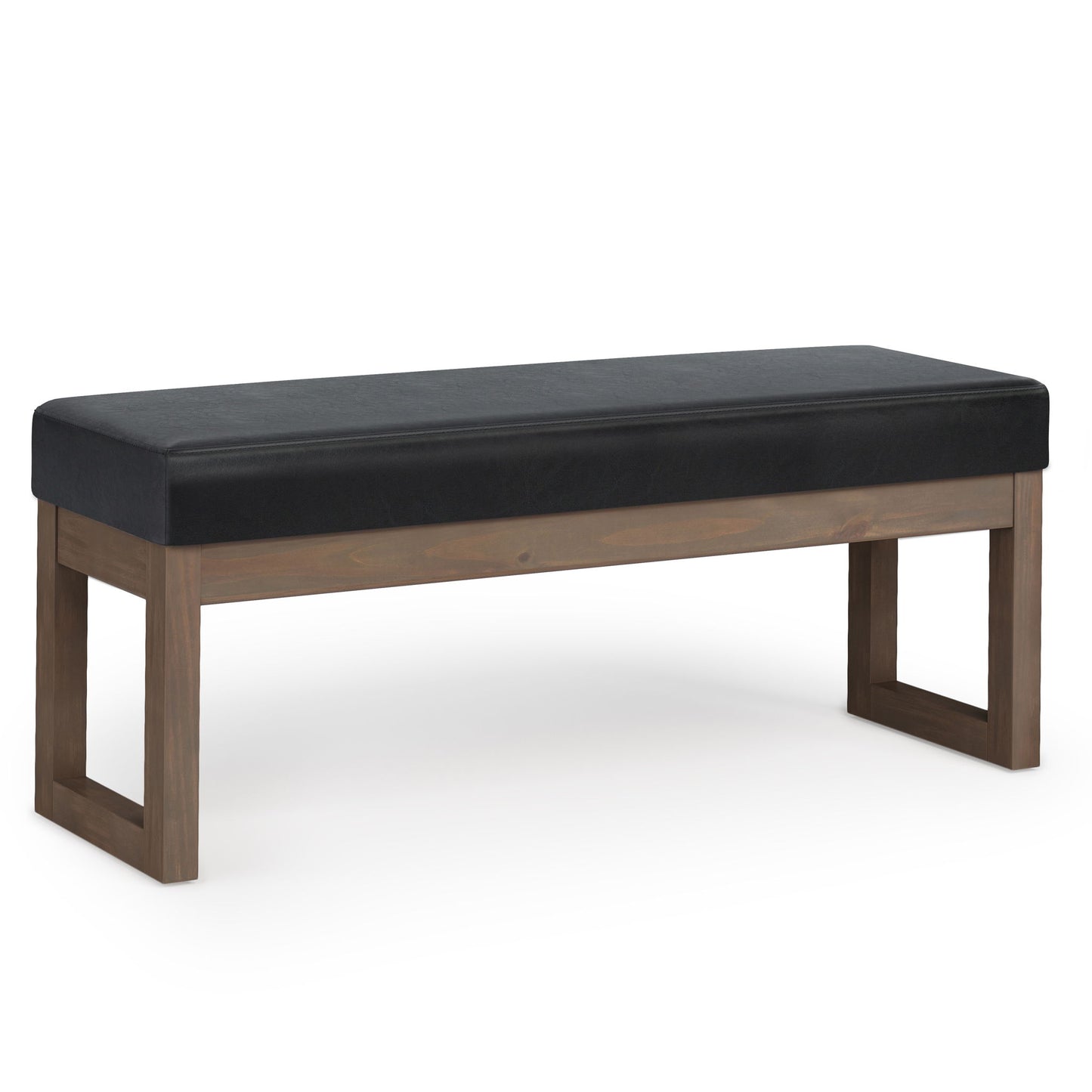 The Milltown - Upholstered Ottoman Bench features a modern, minimalist design with a rectangular black cushioned seat and a wooden frame with open rectangular legs on each side.