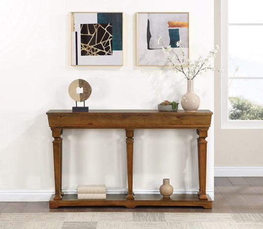 The Garrison Wooden Console Table sits against a white wall, styled with books, vases, and a round sculpture beneath two abstract framed artworks.