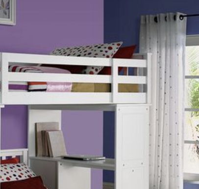 A modern bedroom features the Freya Twin Loft Bed With Storage in white against purple and blue walls. Polka dot pillows and a blanket are on the bed, with a desk, books, and laptop underneath. White dotted curtains cover the window.