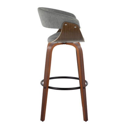 The Vintage Mod Mid Century Modern Fixed Height Barstool Set features a curved wooden frame, four angled legs, a round black footrest, and gray upholstered seat and backrest, shown here from the side.