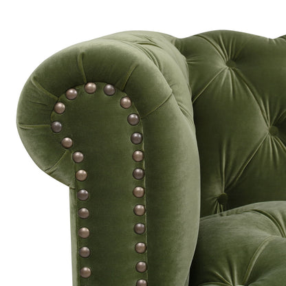 Close-up of the Alto - Tufted Chesterfield Sofa in green velvet, featuring rolled armrests, decorative metal stud accents along the edge, and button-tufted upholstery.