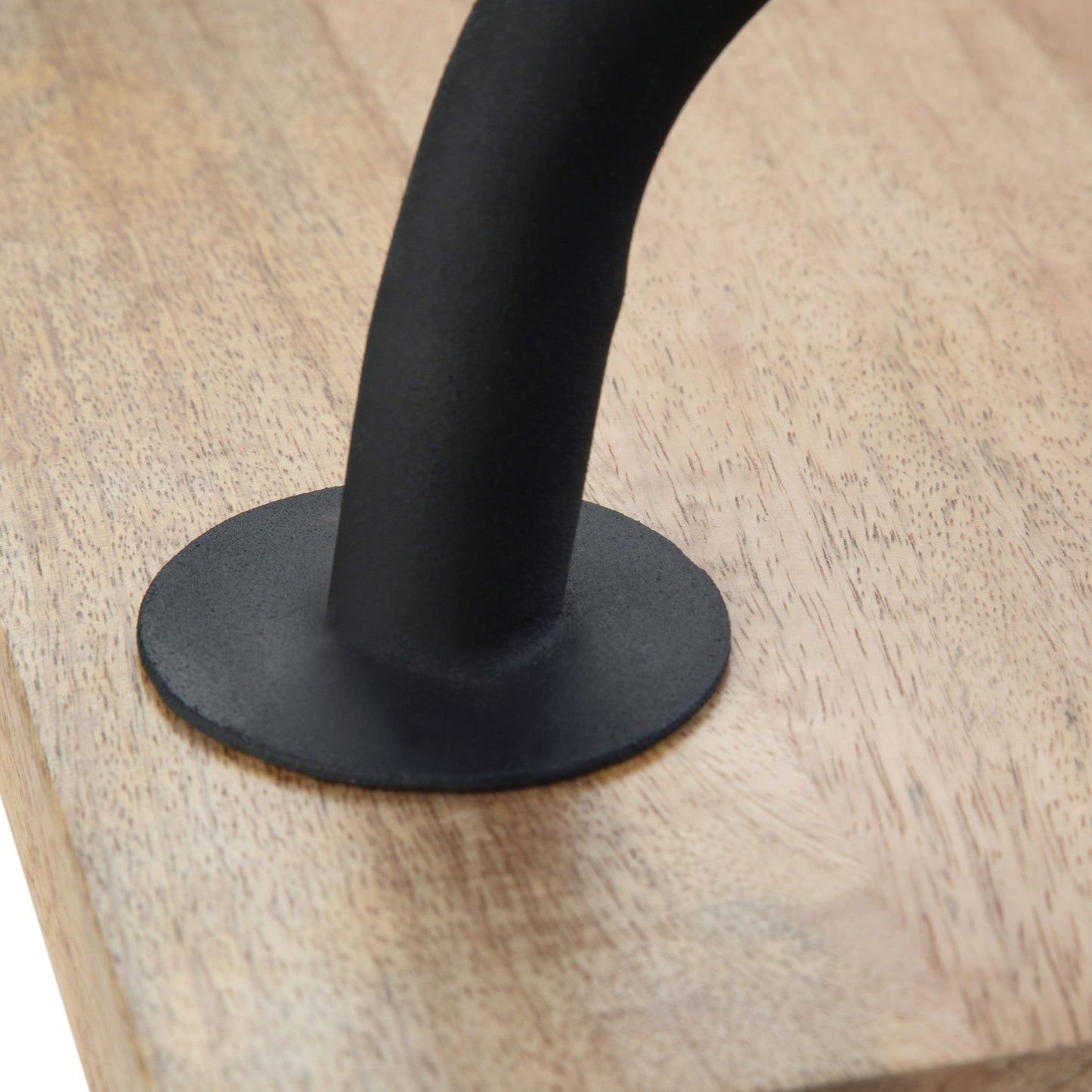 A close-up of the black metal handle with a round base plate on the Berkeley Entryway Bench's light wood surface.