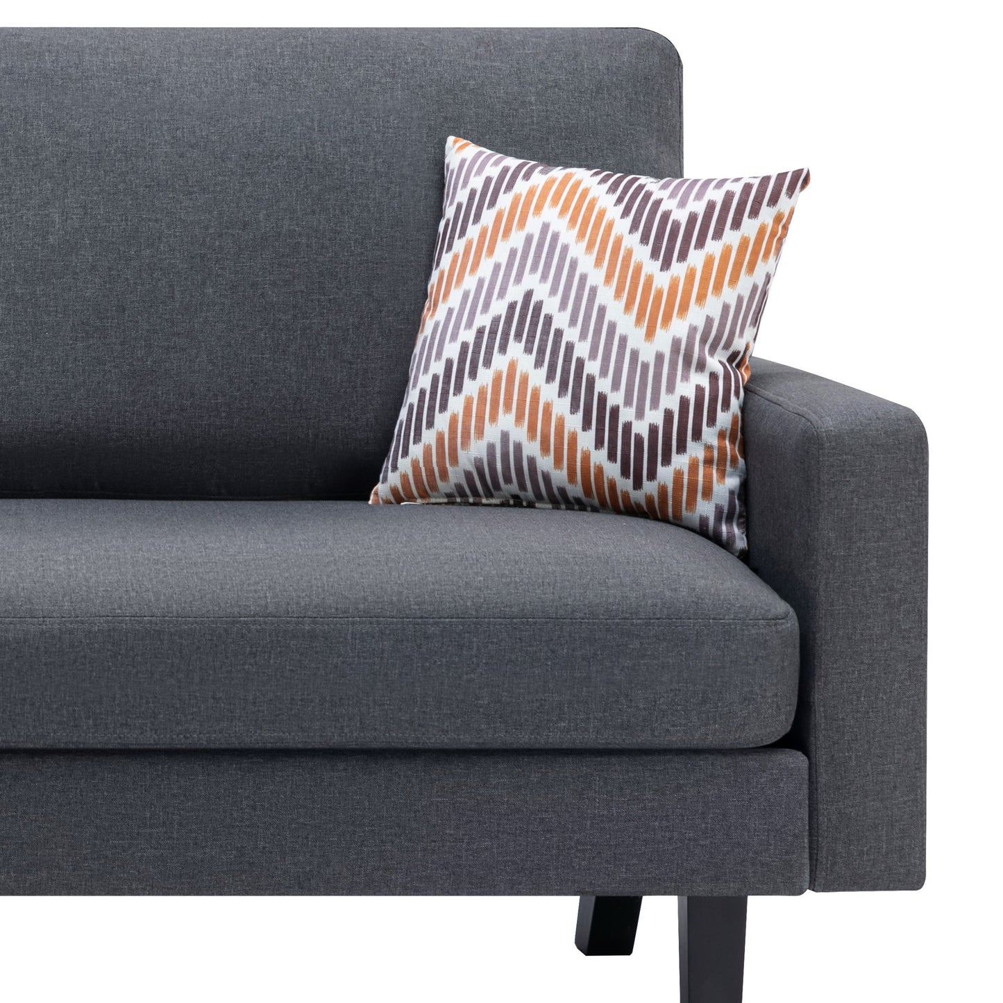 The Bahamas - Minimalistic Sofa with a dark gray finish features two throw pillows, including one with a zigzag pattern in white, orange, and gray tones placed against the right armrest, set against a plain white background.