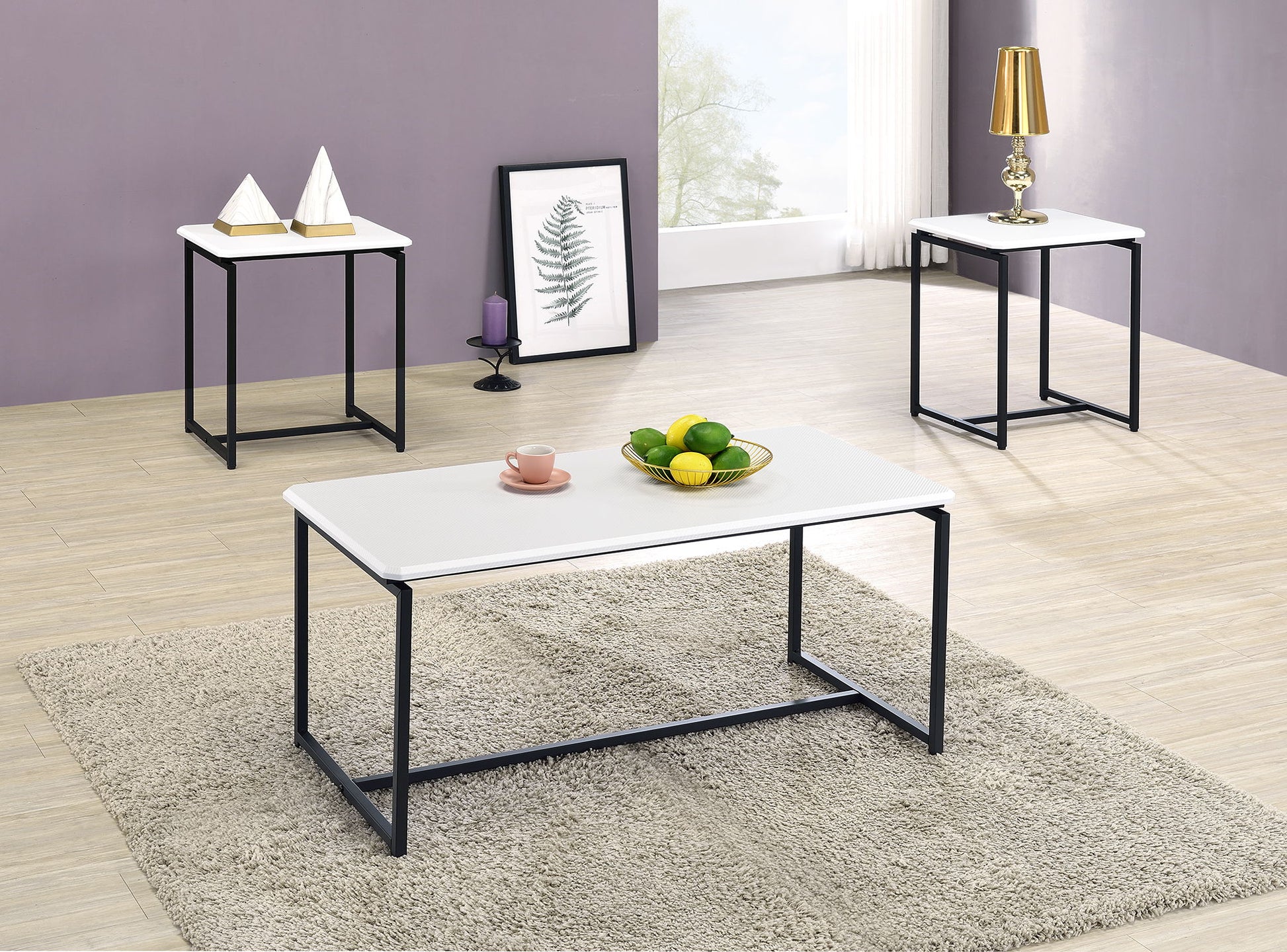 Modern living room with light wood floors, a gray rug, and the GT - 3 Piece Carbon Fiber Wrap Coffee Table And End Table set. Minimalist decor is finished with decorative items, a fruit bowl, lamp, and framed leaf art.