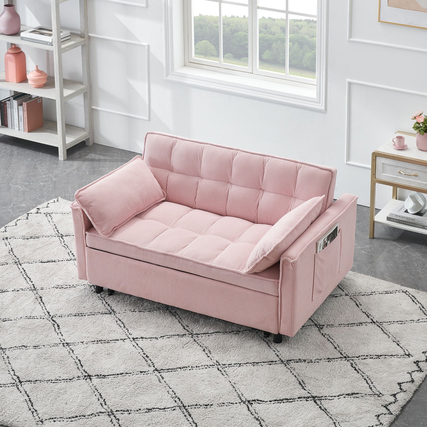 A modern room with a pink Folding Sofa Bed With Adjustable Back Access To Sofa Recliner Single Bed, featuring side pockets, on a white patterned rug. The space includes a window, white walls with molding, bookshelf, and decor on the side table.