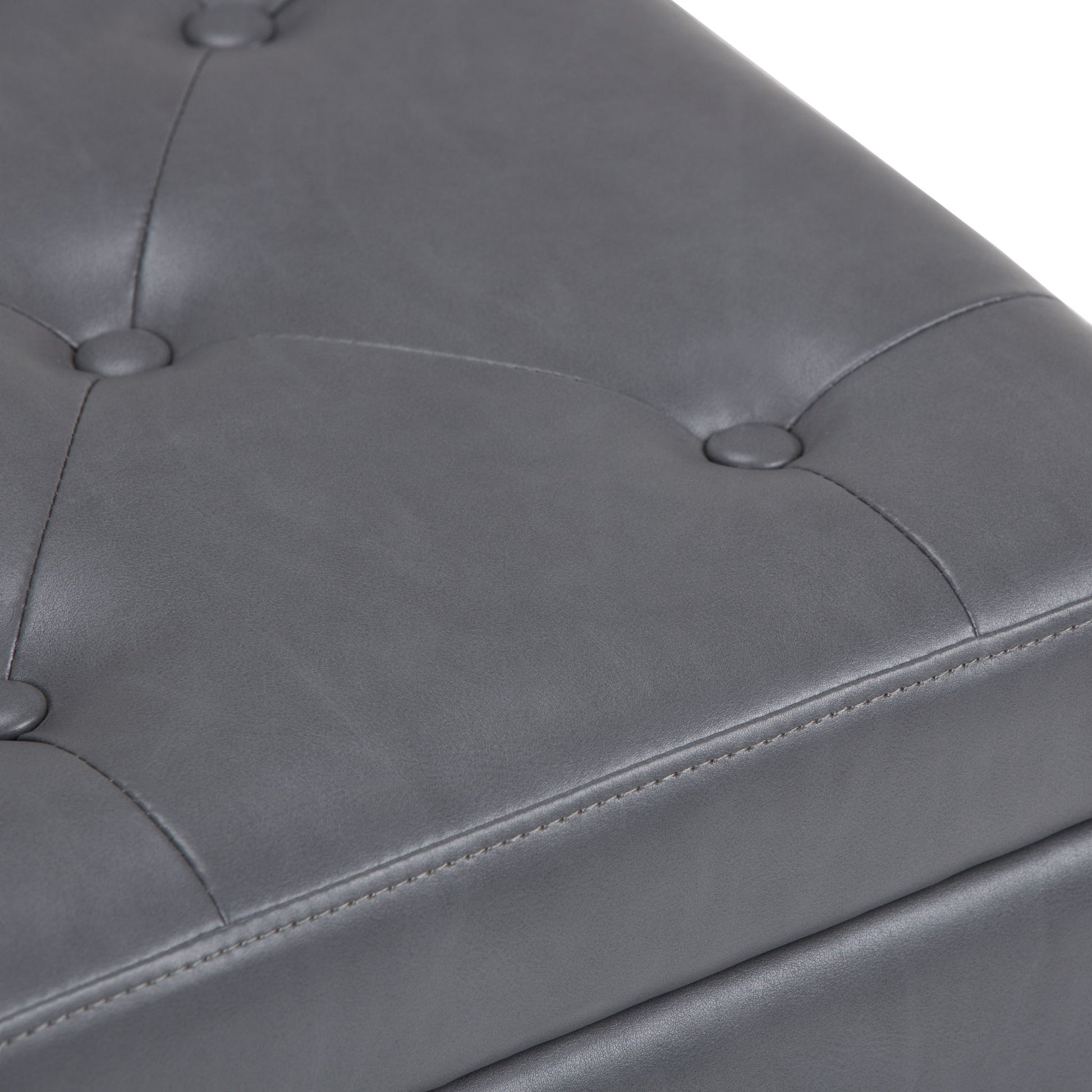 Close-up of the gray, tufted leather surface with button accents and visible stitching on the Hamilton - Upholstered Storage Ottoman.