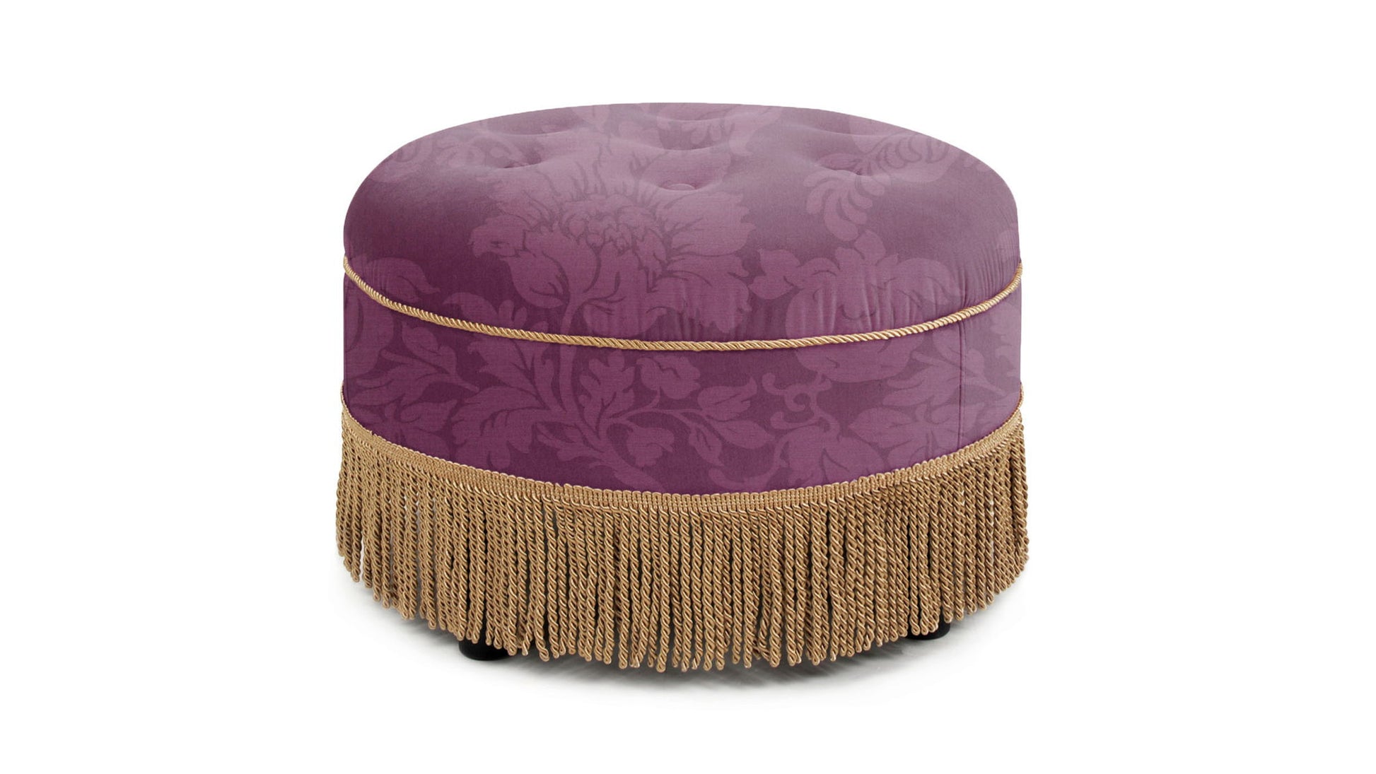 The Yolanda Luxurious Upholstery Round Ottoman features a purple floral pattern, gold cord trim, and long gold fringe at the base, shown against a white background.