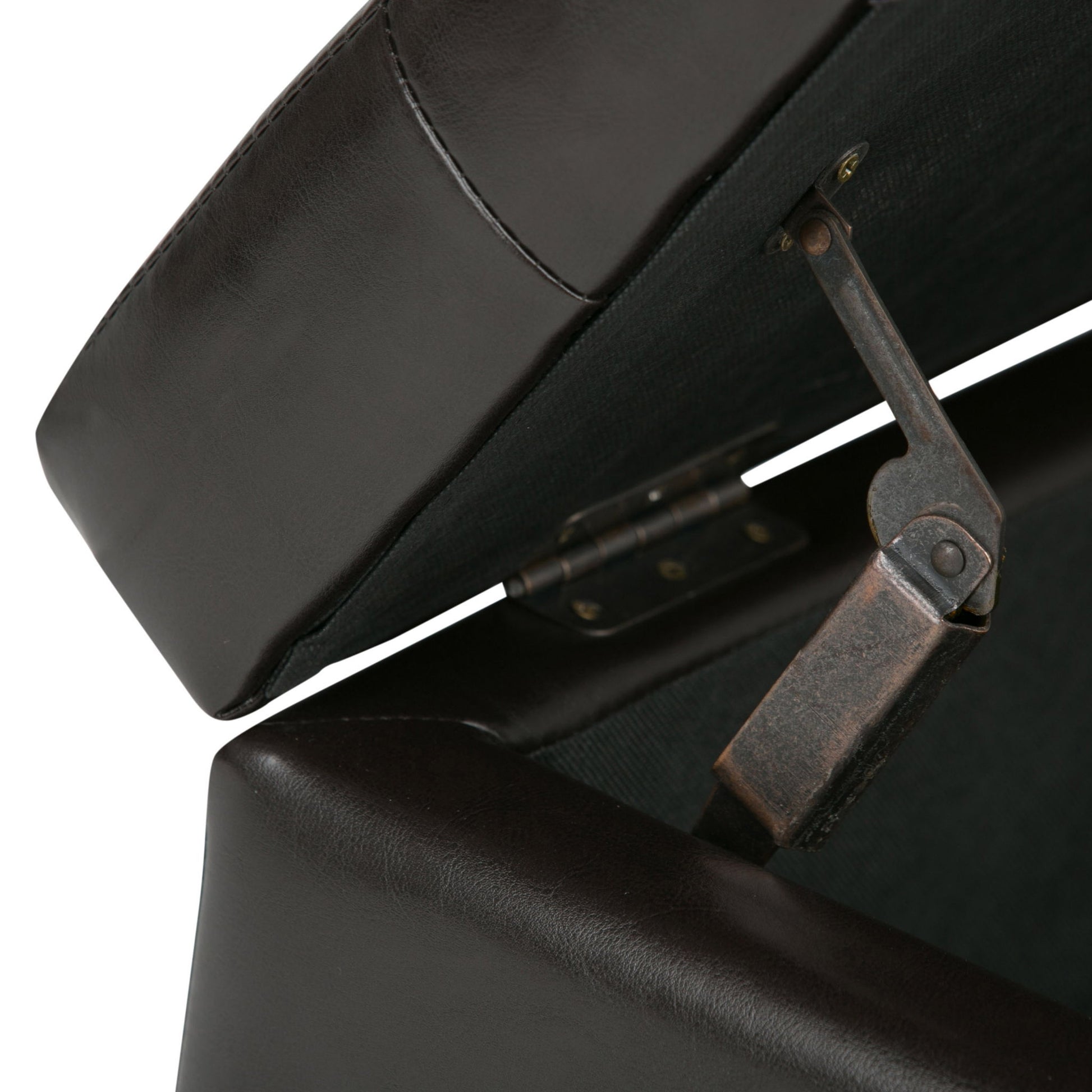 Close-up view of the Cosmopolitan - Upholstered Storage Ottoman in dark brown leather with its lid open, revealing the metal hinge and support mechanism inside.