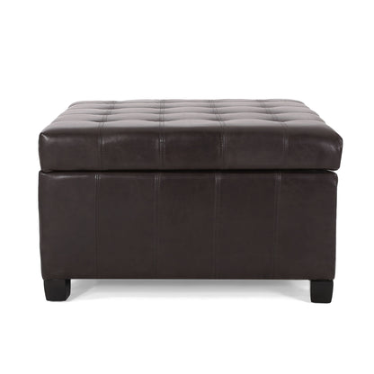 The Isabella Contemporary Ottoman With Storage features a dark brown rectangular leather design, tufted top stitching, short black legs, and a thick cushioned lid.