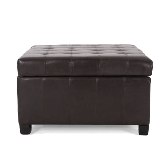 The Isabella Contemporary Ottoman With Storage features a dark brown rectangular leather design, tufted top stitching, short black legs, and a thick cushioned lid.