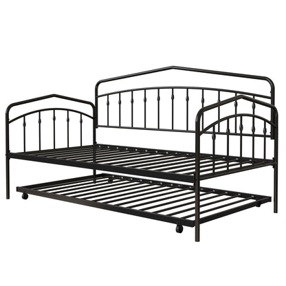 The Fox Daybed With Twin Trundle features a black metal frame with decorative vertical bars, arched accents, slatted bases, and a pull-out trundle on wheels. Both frames are empty and ready for twin-size mattresses.