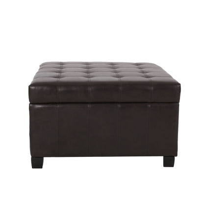 Isabella - Contemporary Ottoman With Storage, shown from the front against a plain white background, features a square dark brown leather design with a tufted cushioned top and short black legs.