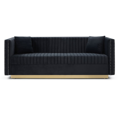 The Contemporary Vertical Channel Tufted Sofa is a modern upholstered black velvet couch featuring vertical stitching, two matching pillows, studded armrest detailing, and a gold base—perfect for your living room.