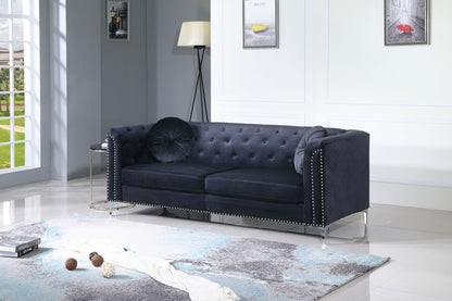 A modern living room features the Elegant Contemporary Sofa in dark blue with decorative pillows, a floor lamp, side table, and artwork on white paneled walls. Natural light from a large window highlights the gray and blue rug.