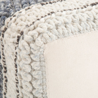 Close-up of the Grady - Handcrafted Square Pouf featuring thick, chunky knit edges in cream and gray with a smooth, light beige fabric panel at the center.
