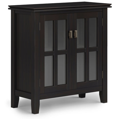 The Couch.com Artisan Low Storage Cabinet in Hickory Brown features wood construction, a dark brown finish, glass-paneled double doors with metal handles, four short legs, and a simple modern design.