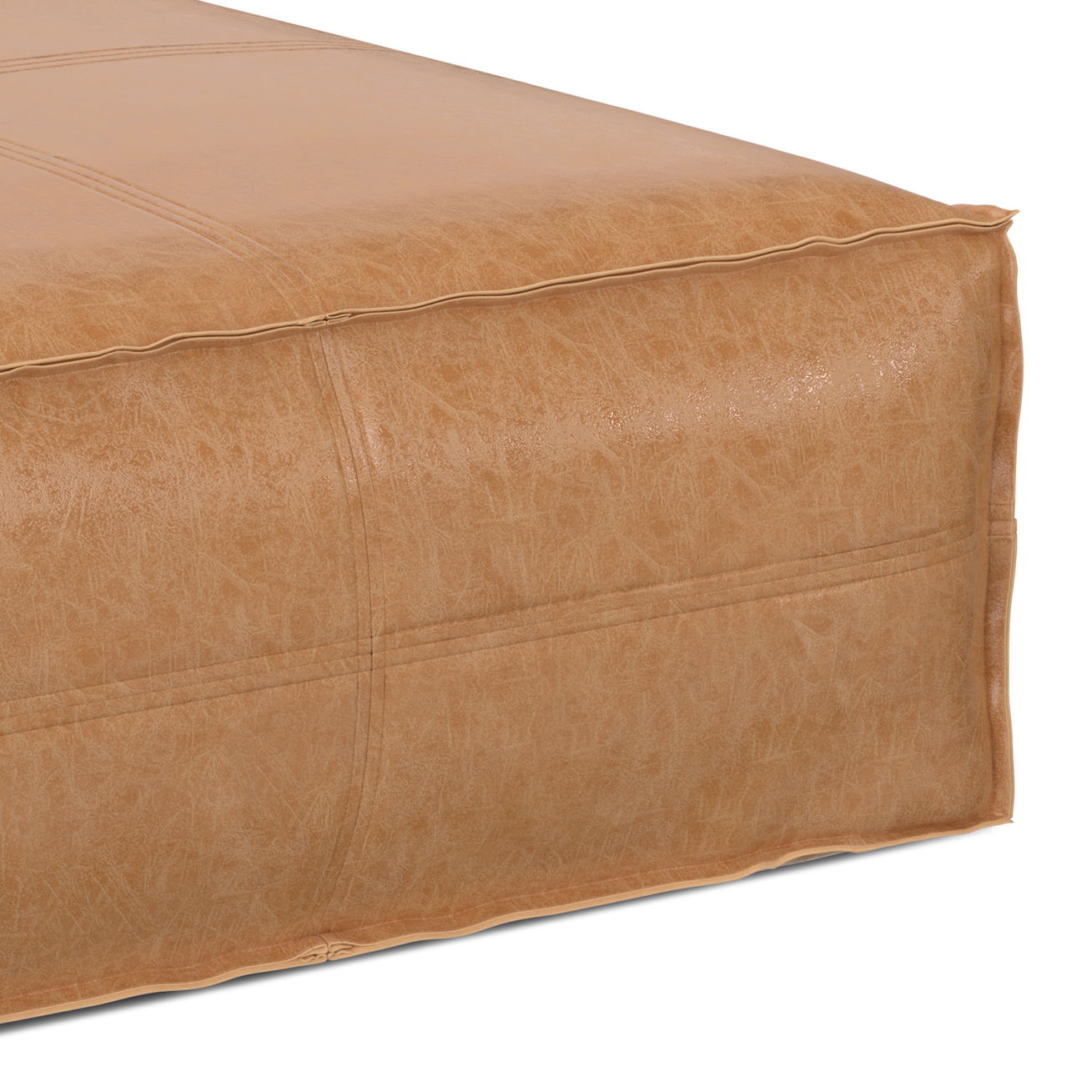 Close-up of the Brody Large Square Coffee Table Pouf, featuring tan leather with visible stitching and a slightly textured surface, set against a white background.