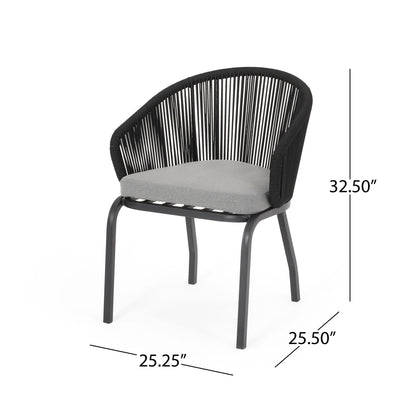 The Outdoor Wicker Chair features a modern black design with a curved, open woven backrest, powder-coated iron legs, and a gray cushioned seat. Dimensions: 32.5" H x 25.25" W x 25.5" D.