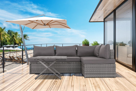 A contemporary deck features a Patio Sofa With Cushions - Gray and table beneath a large umbrella, glass doors, and lush plants—all overlooking a sunny beach with palm trees.