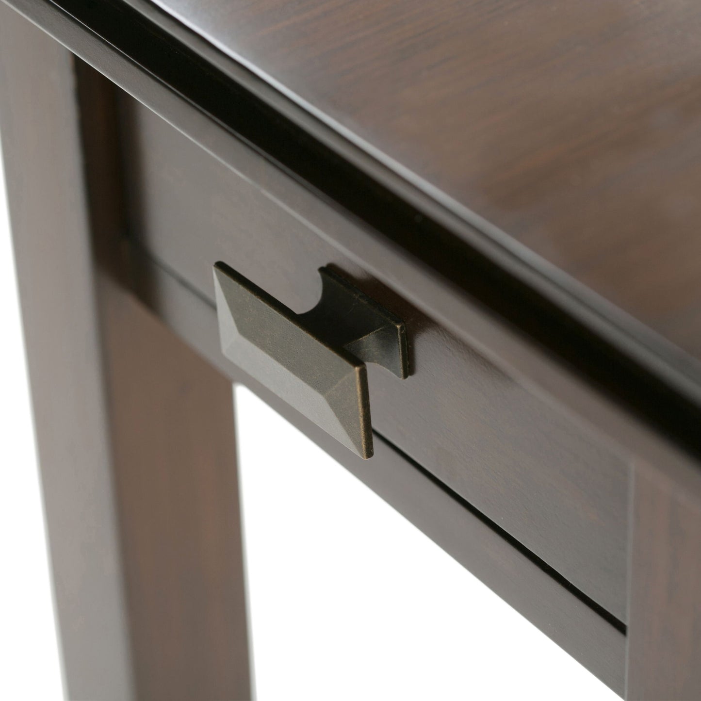 Close-up of the Artisan - Handcrafted Narrow Side Table, showing its dark wood, rectangular drawer with geometric bronze handle, smooth finish, and sturdy legs.