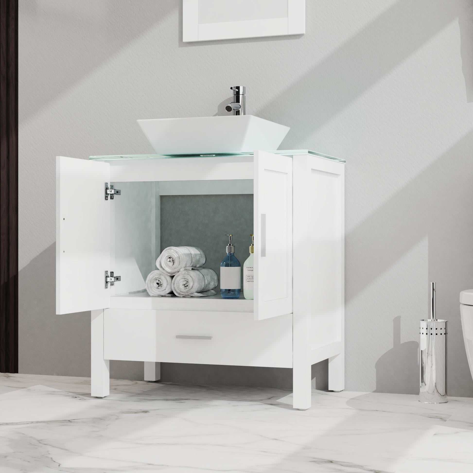 The Bathroom Vanity And Sink Combo Glass Top Cabinet With Mirror features open cabinet doors displaying towels and bottles, a square vessel sink above, and a white drawer below, set against a light wall with a marble floor.