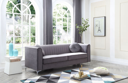 A modern living room featuring the Delray Micro Suede Sofa in gray, a geometric rug, round pillow, vases on a side table, wall art, potted plant, and large arched windows streaming in natural light.