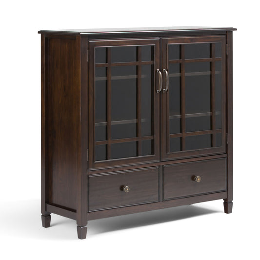 The Connaught Tall Storage Cabinet in Dark Chestnut Brown features two glass-paneled grid doors, metal handles, two bottom drawers, and stands on four short legs for a modern, elegant look.