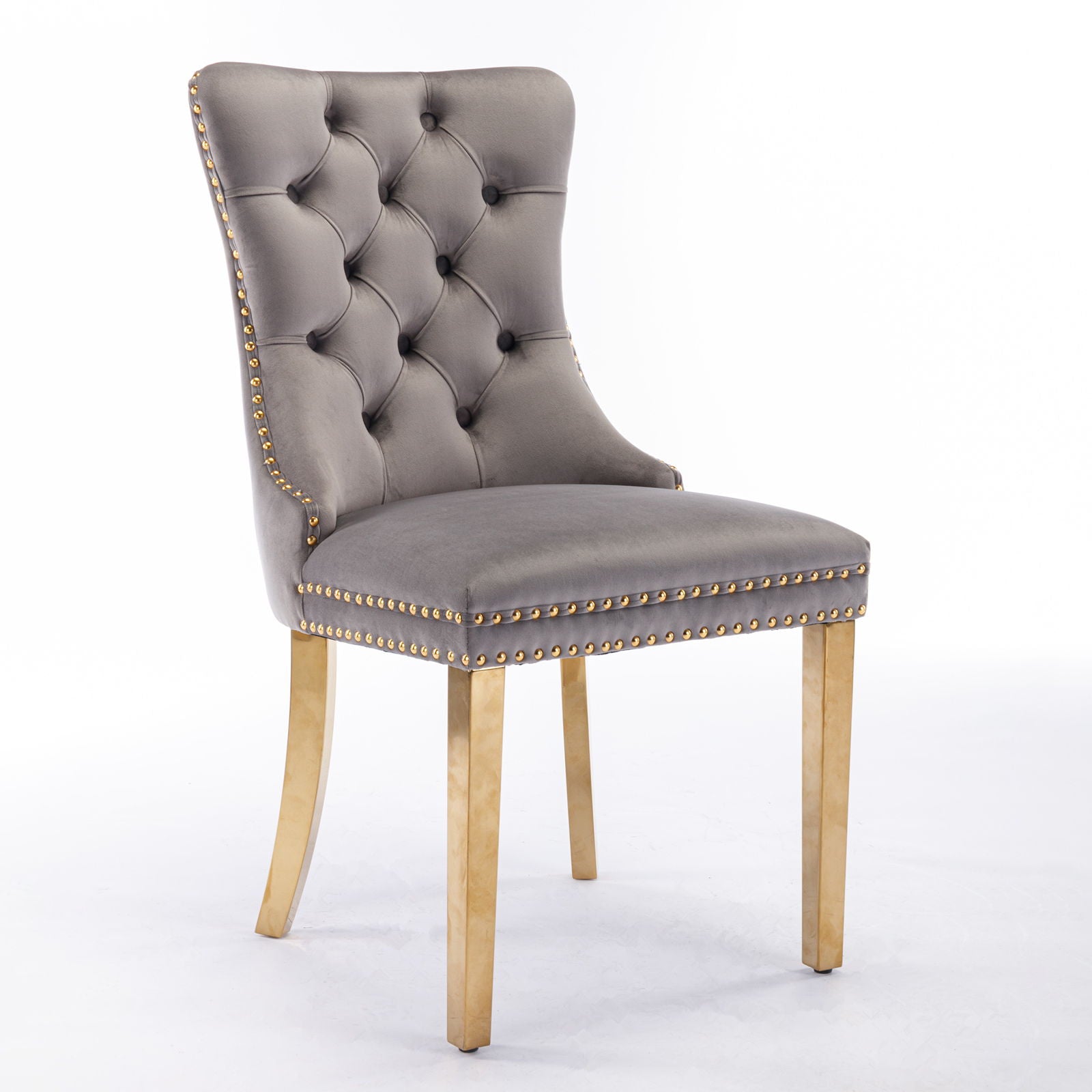 The Nikki dining chair set features modern, high-end gray velvet upholstery, a tufted high back, gold nailhead trim, and golden stainless steel plated legs, shown against a plain white background.