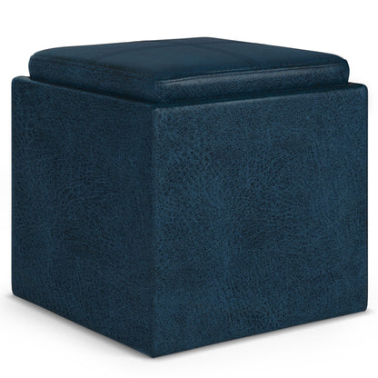The Rockwood Upholstered Cube Storage Ottoman With Tray features a navy blue, textured fabric, cushioned top, and minimalist modern design with clean lines and soft edges.