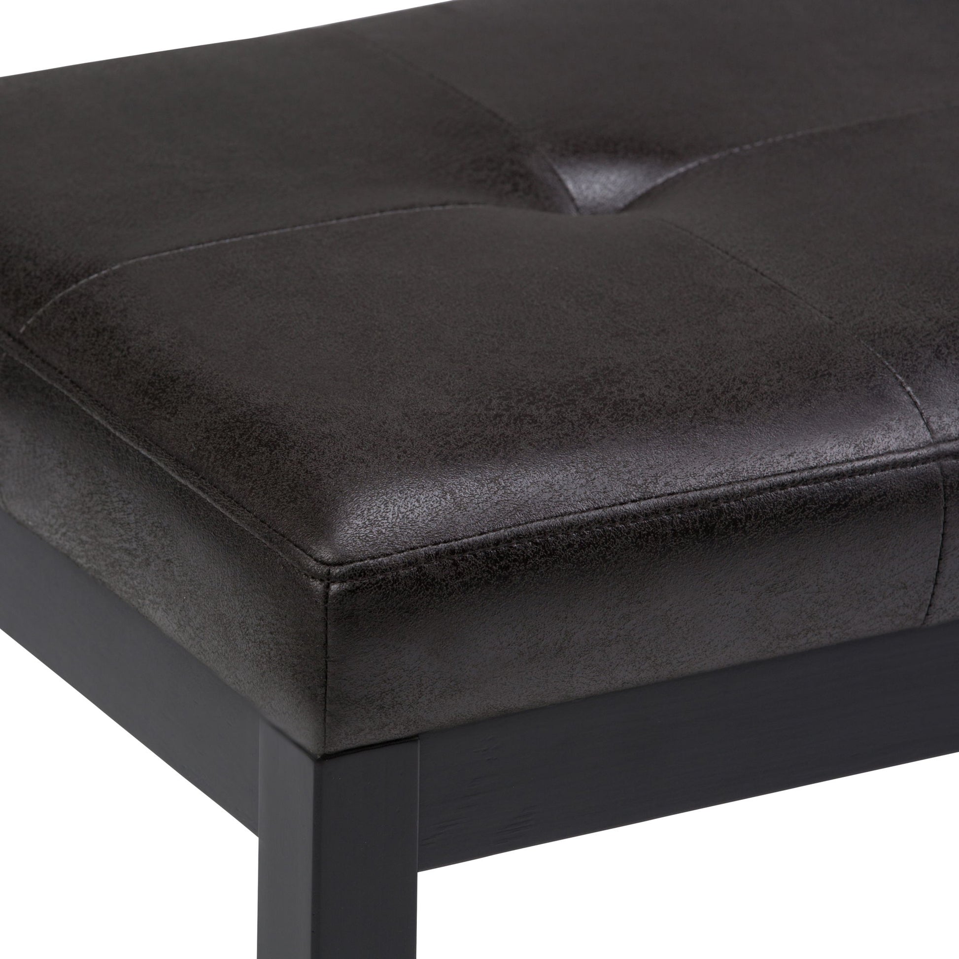 A close-up view of the Lacey - Upholstered Tufted Ottoman Bench, featuring black faux leather with visible stitching and a dark wooden frame.