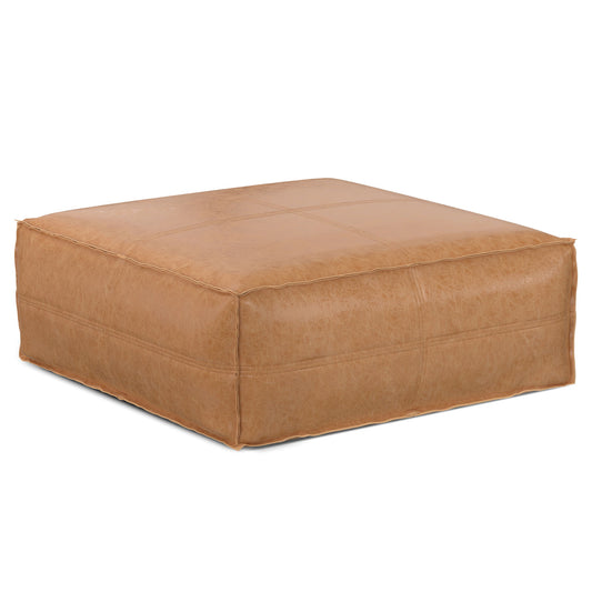 The Brody Large Square Coffee Table Pouf features a tan leather finish with visible seams and a soft, cushioned surface, shown against a white background.