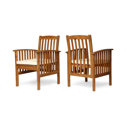 The Casa Acacia Dining Chair Set With Cushions includes two wooden chairs with vertical slat backs and sides, light-colored seat cushions, and are displayed at an angle to show both front and side views.