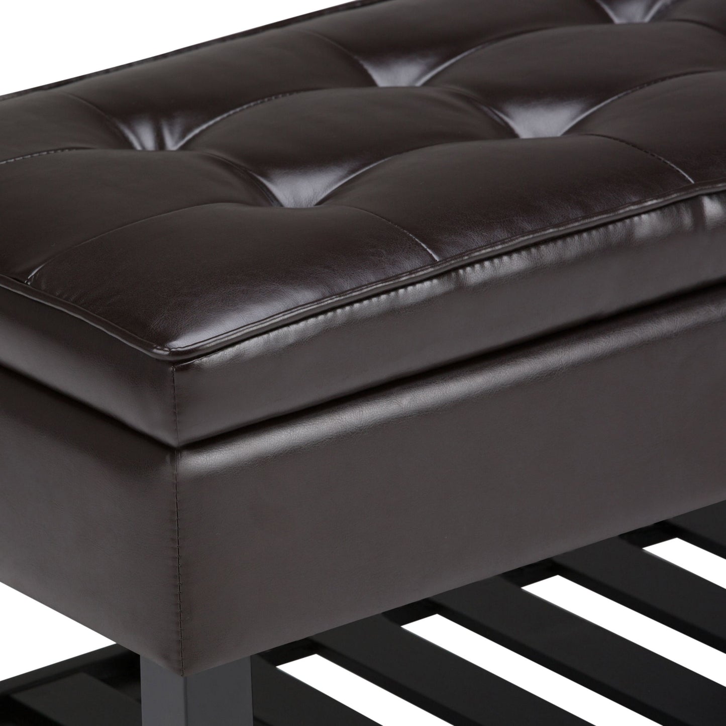 Close-up of the Cosmopolitan - Storage Ottoman Bench With Open Bottom in Tanners Brown, featuring tufted leather upholstery, visible stitching, dark legs, and a slatted wooden shelf beneath.