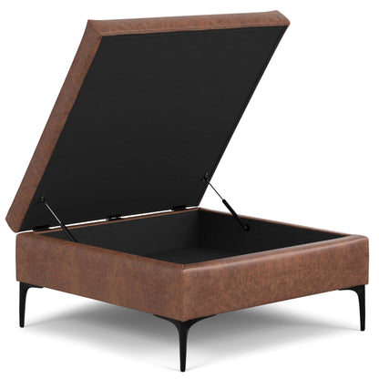 The Rebecca Multifunctional Coffee Table Storage Ottoman features a brown leather finish, black metal legs, and a lift-up lid for interior storage; shown on a white background.