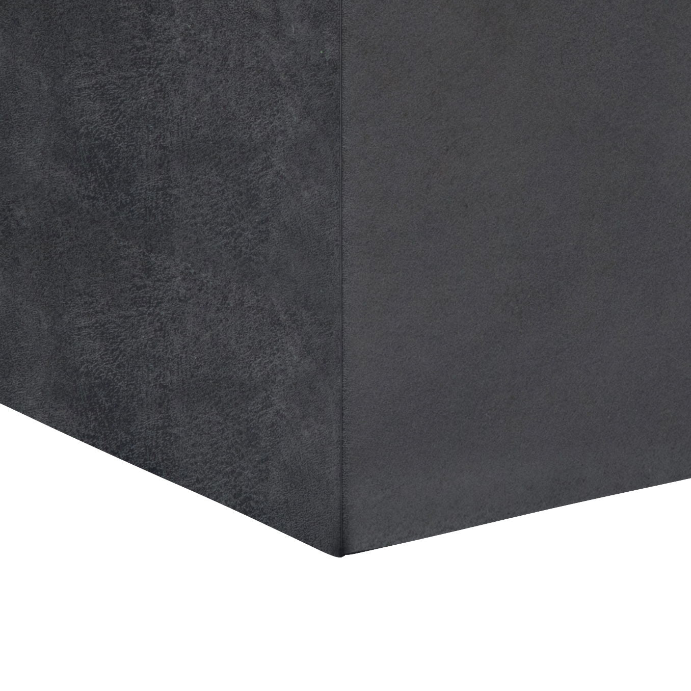 Close-up view of the corner of a dark gray Rockwood Upholstered Cube Storage Ottoman With Tray, set against a plain white background.