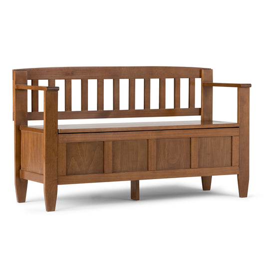 The Brooklyn Entryway Storage Bench in Medium Saddle Brown features a slatted backrest, straight armrests, built-in seat storage, and a simple, classic design with a warm brown finish.