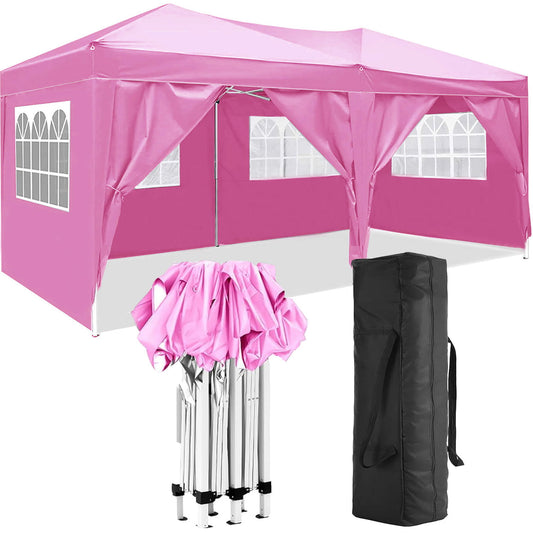 The 10'X20' Folding Canopy features a pink cover, partially folded metal frame, 6 removable windowed sidewalls, and a black carrying bag, ideal for parties, camping, or weddings; shown on a white background.