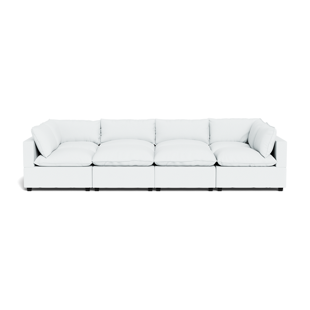 The Kova Pillow Cushion Grand Pit is a modern, white modular sectional with deep seats and plush cushions, made of five connected sections, shown from the front against a plain background.