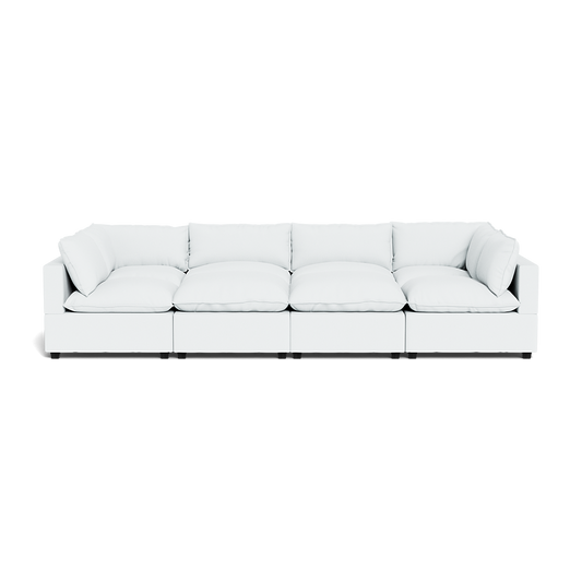 The Kova Pillow Cushion Grand Pit is a modern, white modular sectional with deep seats and plush cushions, made of five connected sections, shown from the front against a plain background.