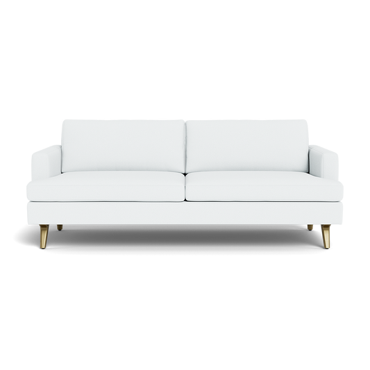 The Lido Sofa 75" is a modern white sofa with two seat and back cushions, low square armrests, and angled wooden legs tipped with gold, shown from the front against a black background.