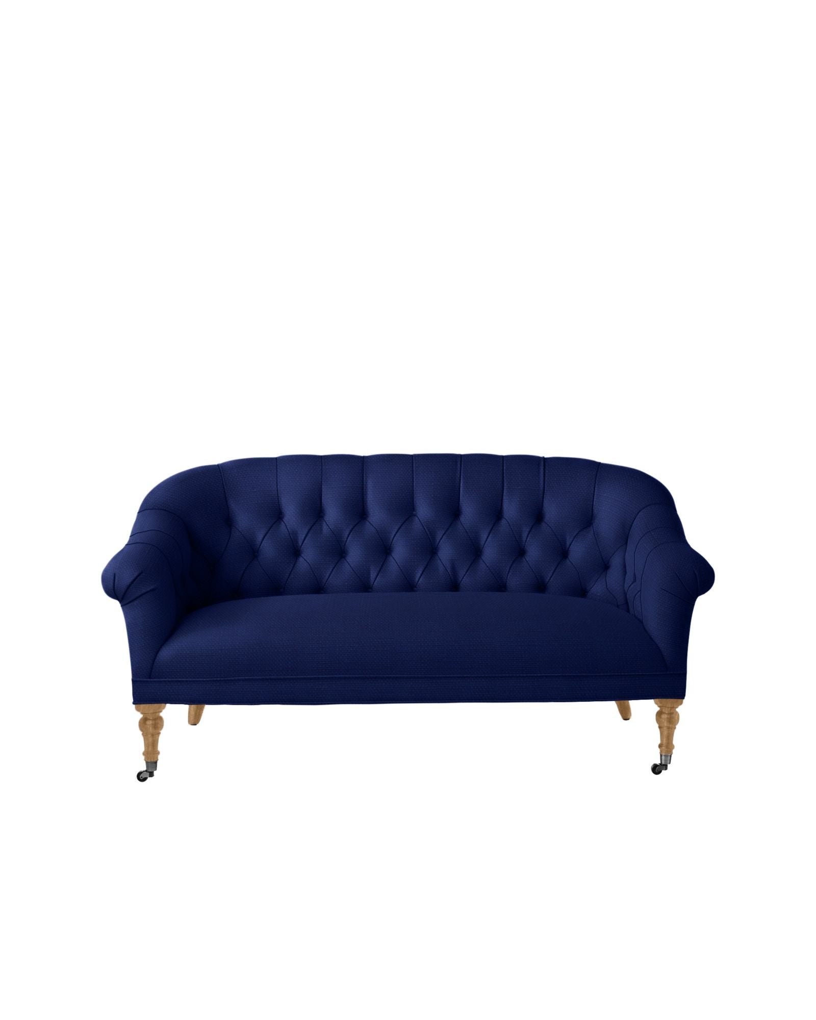 The Paxton Tufted Loveseat, in a rich deep blue color, showcases a curved back and wooden legs with small caster wheels. It is displayed against a plain white background.