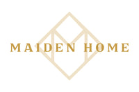 The image displays the logo for Maiden Home. It features the text "MAIDEN HOME" in gold capital letters, with a geometric, diamond-shaped design in the background. The design includes an abstract letter "M" integrated into the diamond shape.