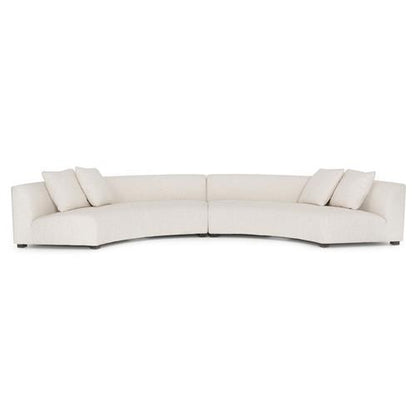 Introducing the Zoe Modern White Performance Black Birch Wood Piece Curved Sectional: a spacious and contemporary sofa featuring three seat cushions and four square pillows. Its low-backed design offers a sleek, minimalist style, making it an ideal addition to modern interiors.