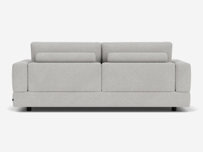 The Stage Track Sofa features a modern, light gray design with a minimalist aesthetic. It has a rectangular shape, two attached back cushions, and short black legs. The upholstery is soft and textured, making it an excellent addition to any contemporary living space.